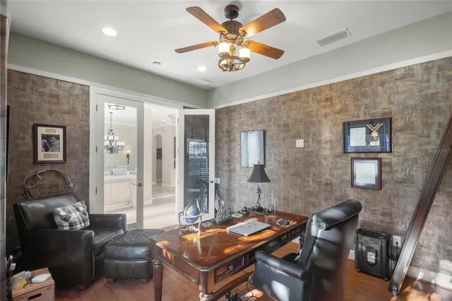 a bedroom with a bed and a fan