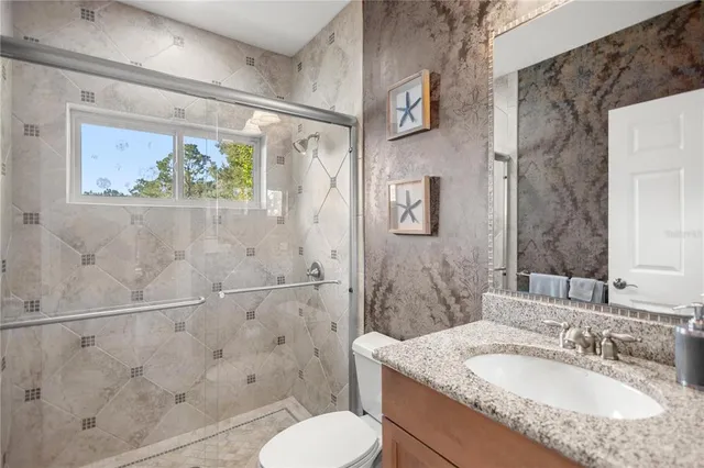 an empty room with closet and a ceiling fan