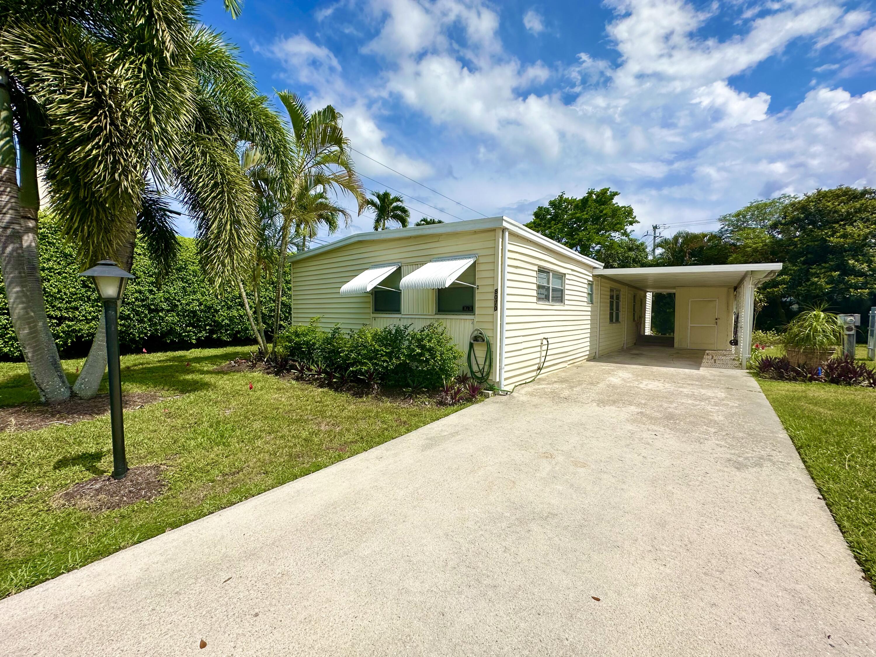 8070 South Street Boca Raton, FL 33433 - Photo 1 of 35 a view of a house with yard and a garden