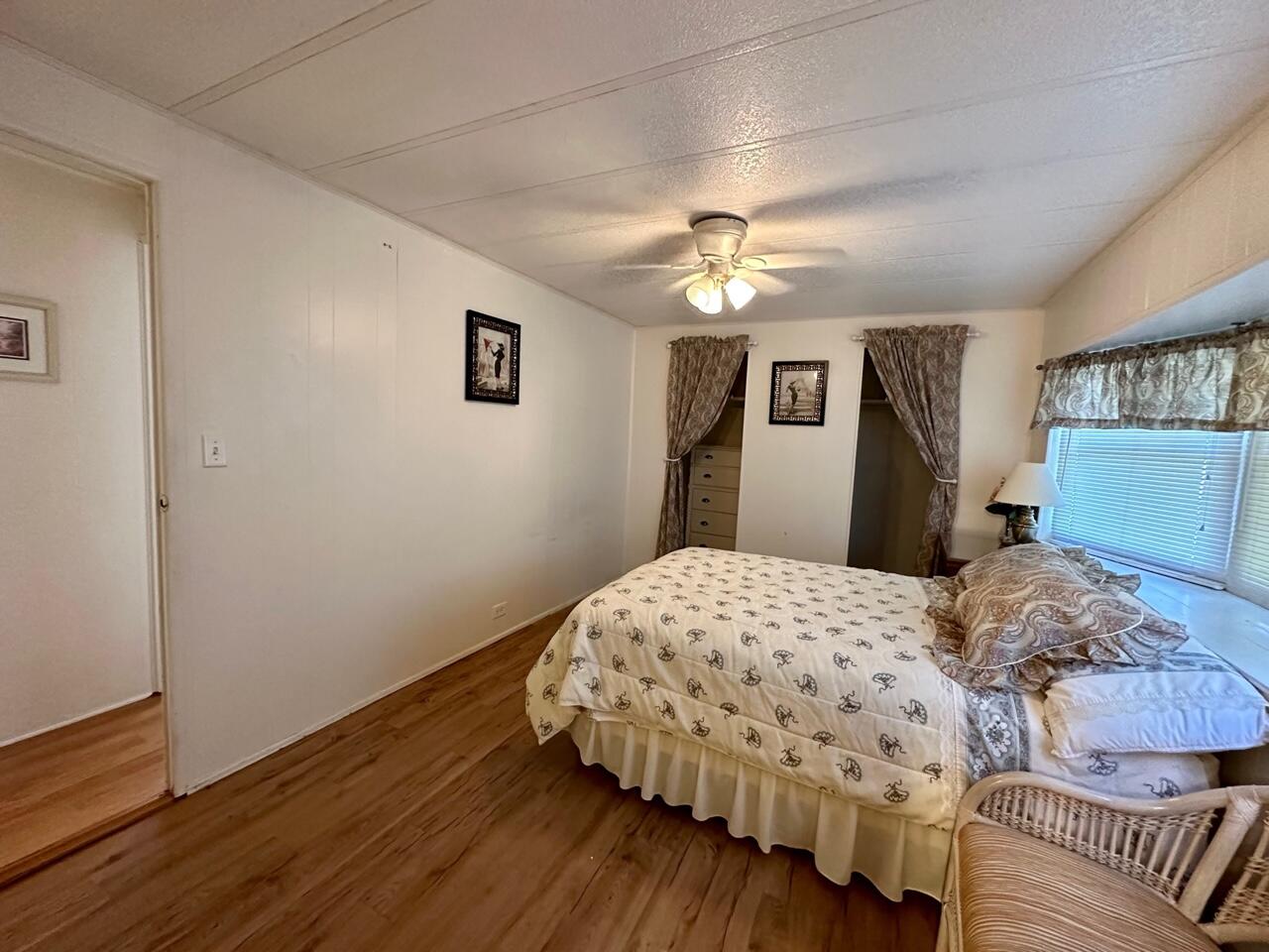 8070 South Street Boca Raton, FL 33433 - Photo 11 of 35 a bedroom with a bed and wooden floor