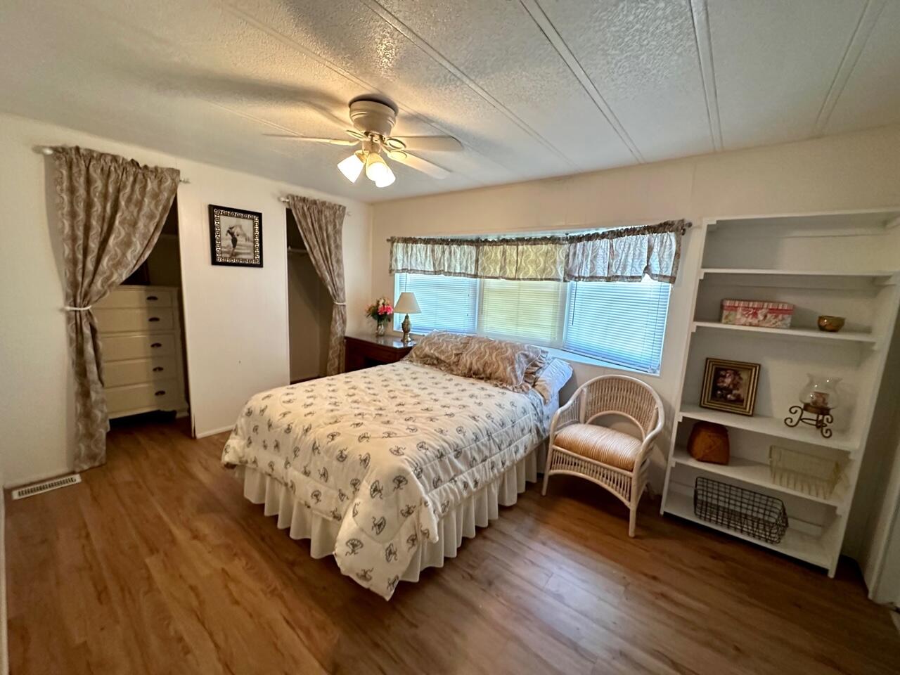 8070 South Street Boca Raton, FL 33433 - Photo 5 of 35 a bedroom with a bed and a chandelier