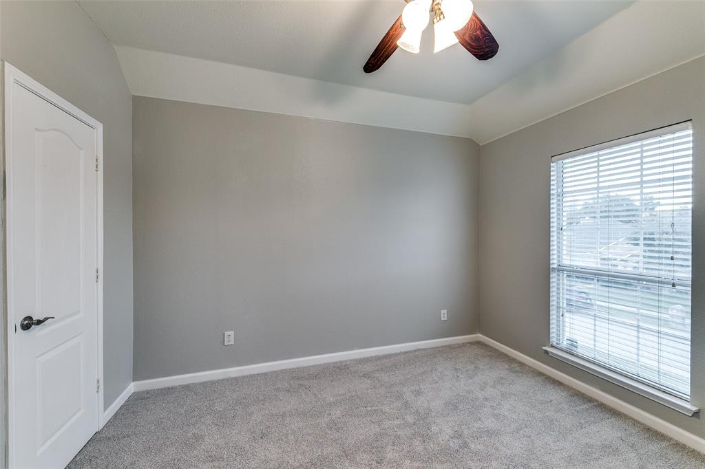4532 Crown Ridge Drive Plano, TX 75024 - Photo 16 of 25 Carpeted interior room with a tray ceiling and a ceiling fan with integrated lighting