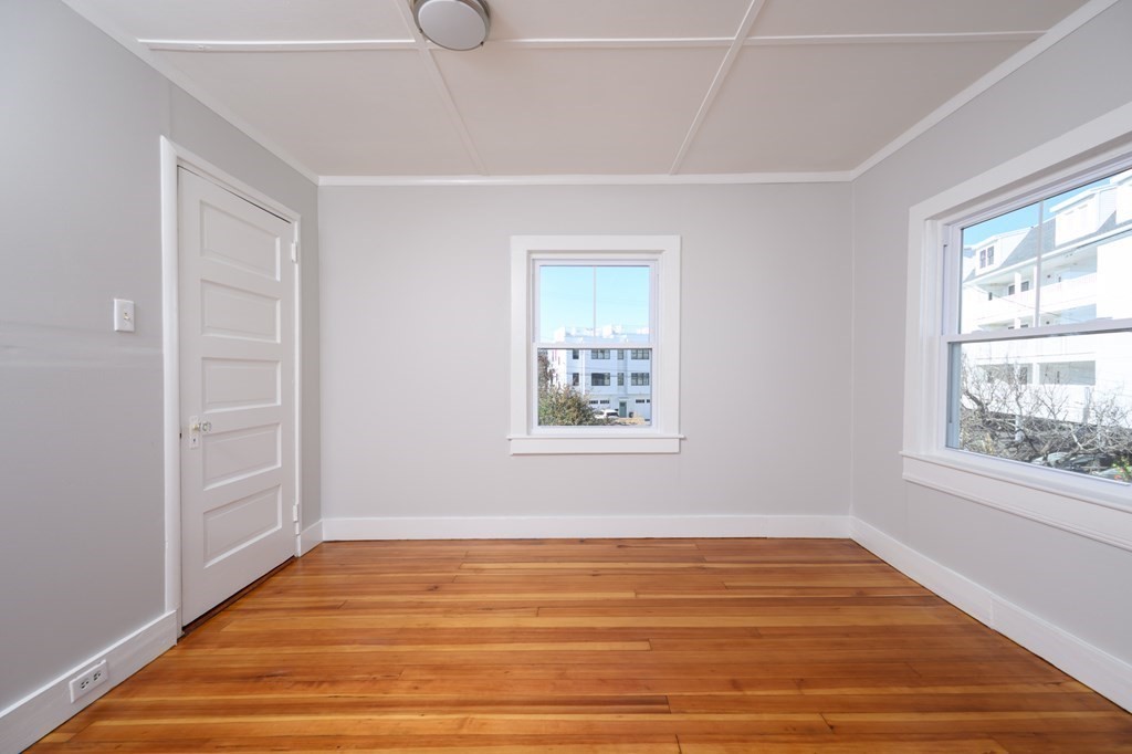 6 Atherton Road, Unit 2 Hull, MA 02045 - Photo 13 of 24 a view of an empty room with wooden floor and a window