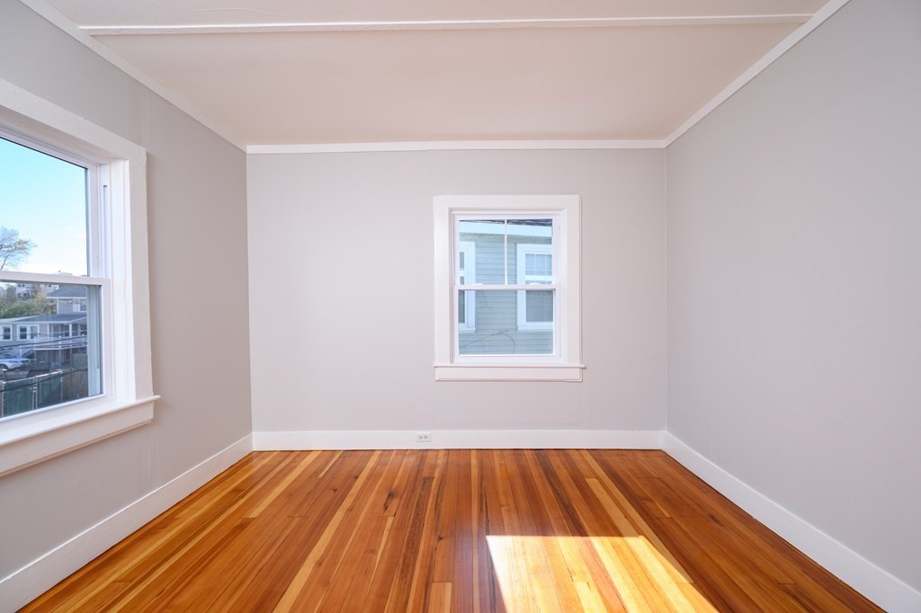 6 Atherton Road, Unit 2 Hull, MA 02045 - Photo 15 of 24 an empty room with a window and wooden floor
