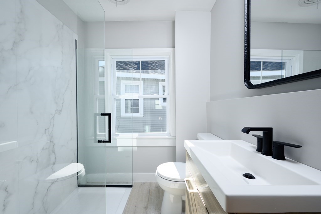 6 Atherton Road, Unit 2 Hull, MA 02045 - Photo 17 of 24 a bathroom with a sink toilet and shower