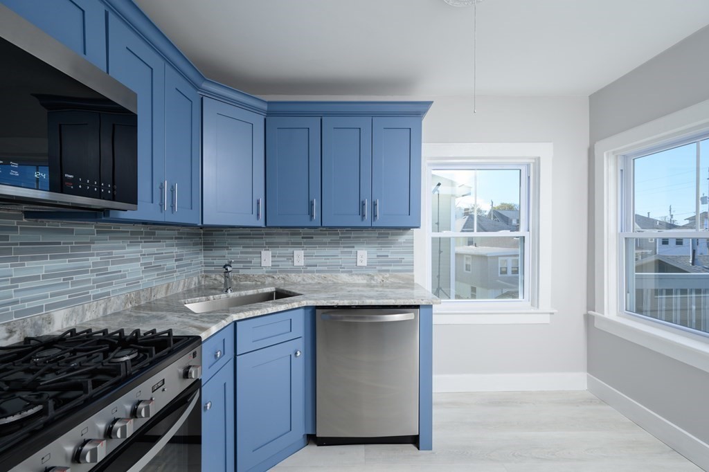 6 Atherton Road, Unit 2 Hull, MA 02045 - Photo 6 of 24 a kitchen with stainless steel appliances granite countertop a stove and a microwave