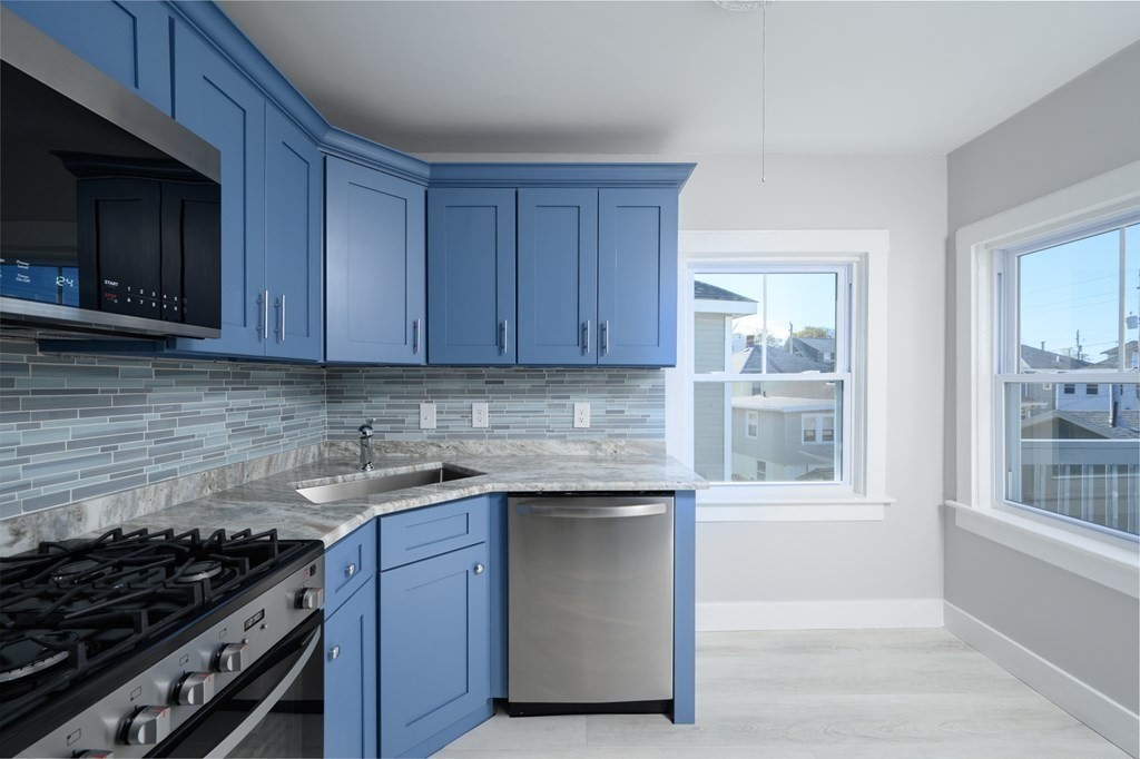 6 Atherton Road, Unit 2 Hull, MA 02045 - Photo 7 of 24 a kitchen with stainless steel appliances granite countertop a stove and a microwave