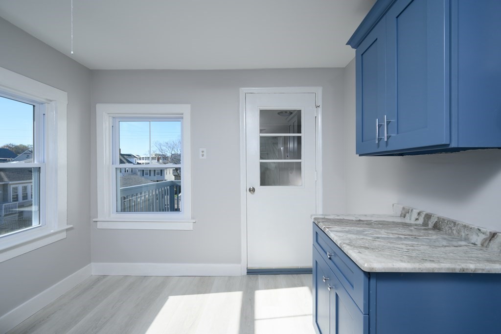 6 Atherton Road, Unit 2 Hull, MA 02045 - Photo 8 of 24 a kitchen with granite countertop a sink window and cabinets