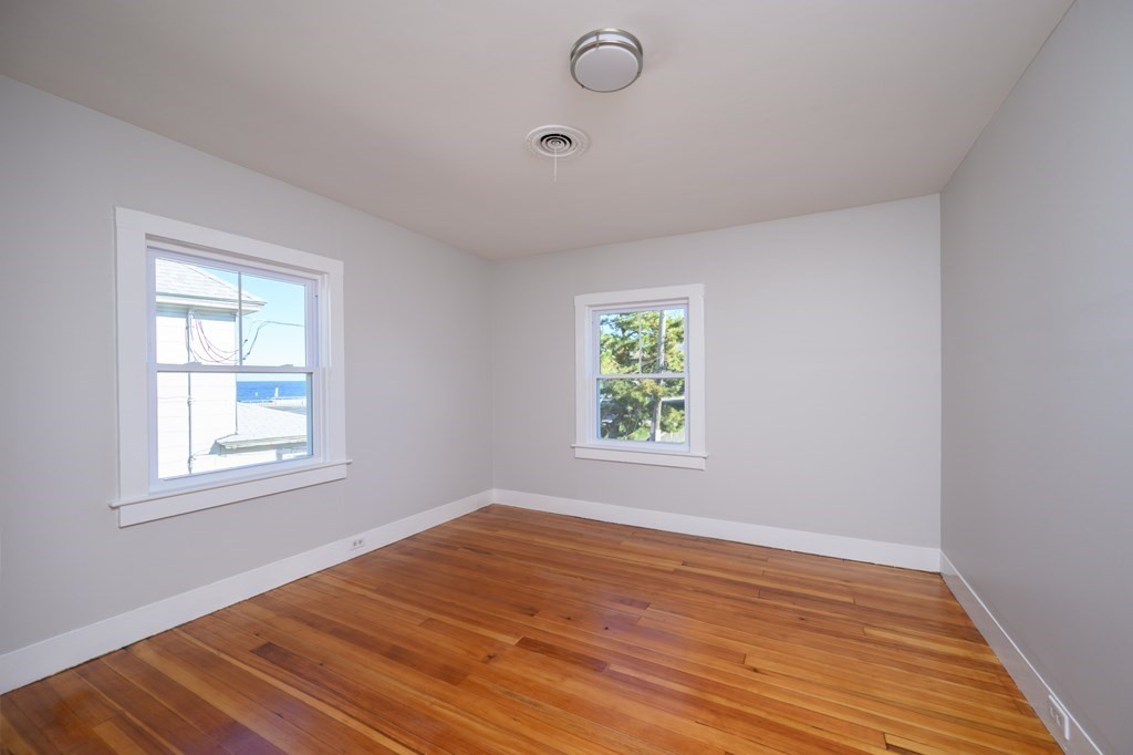6 Atherton Road, Unit 2 Hull, MA 02045 - Photo 10 of 24 an empty room with wooden floor and windows