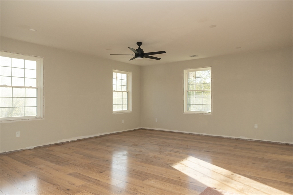 28 Marion Road Rochester, MA 02770 - Photo 17 of 23 an empty room with chandelier fan and windows