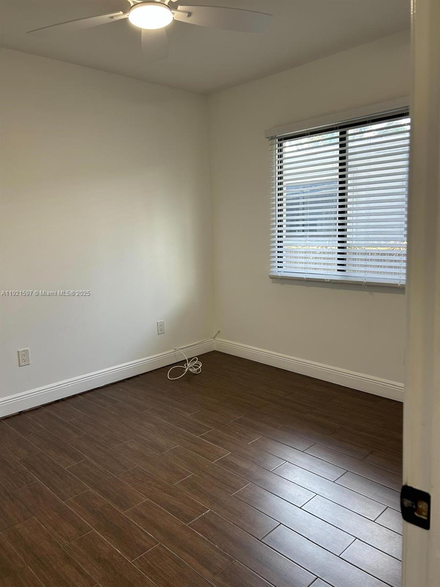 5790 Southwest 5th Street Miami, FL 33144 - Photo 13 of 31 a view of an empty room with wooden floor and a window