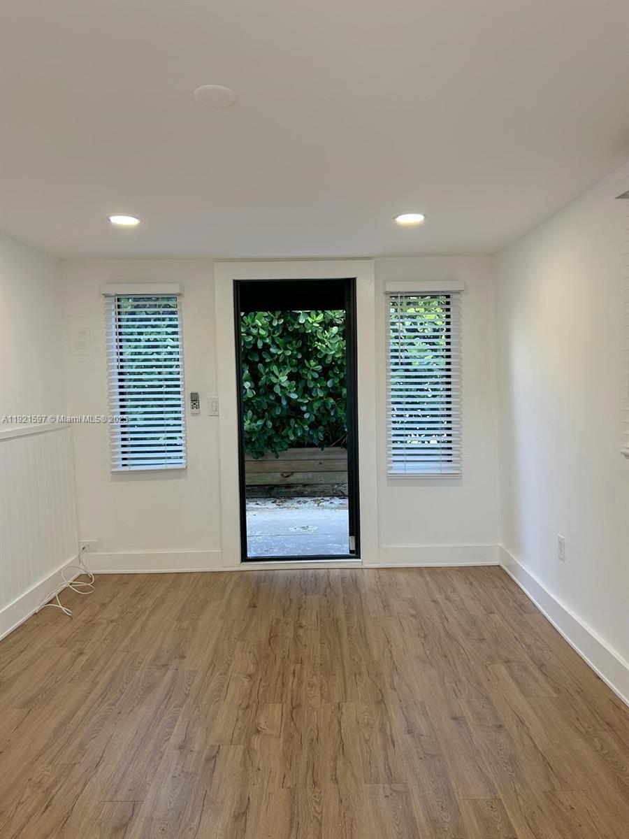 5790 Southwest 5th Street Miami, FL 33144 - Photo 21 of 31 an empty room with wooden floor and windows
