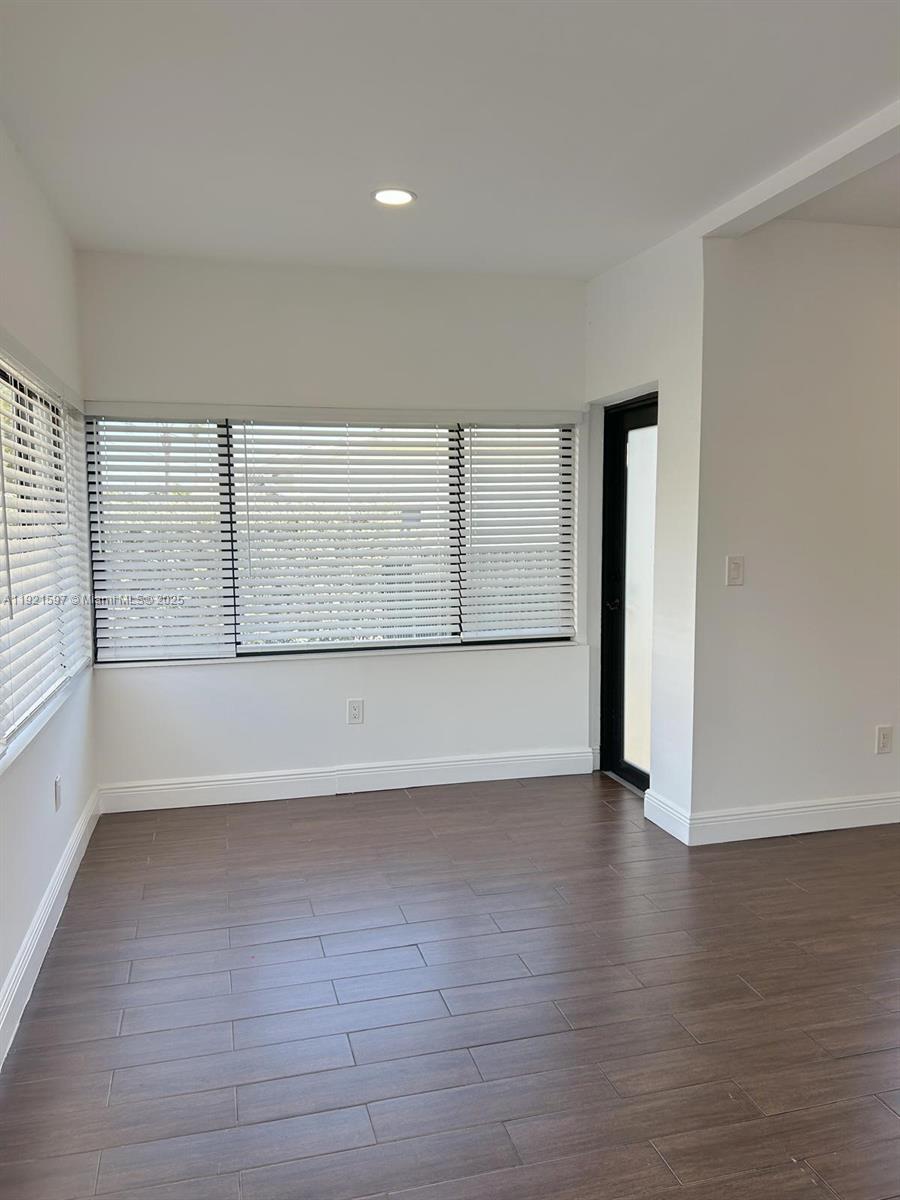5790 Southwest 5th Street Miami, FL 33144 - Photo 4 of 31 wooden floor in an empty room with a window