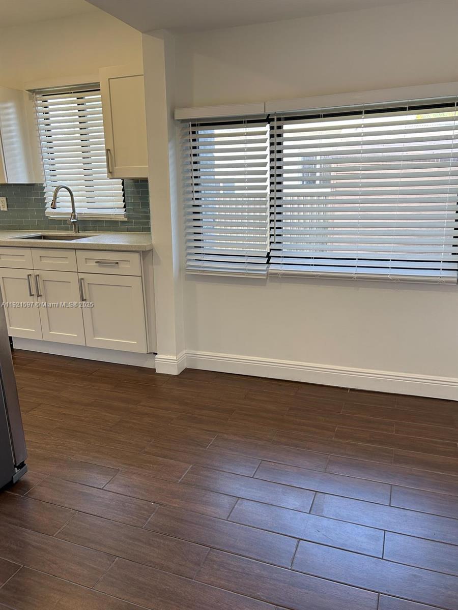 5790 Southwest 5th Street Miami, FL 33144 - Photo 9 of 31 a view of a kitchen with wooden floor and a sink