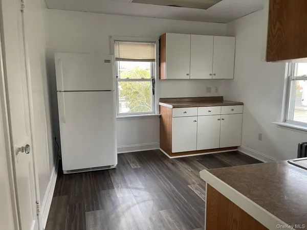 a kitchen with cabinets a sink and wooden floor