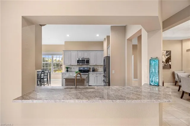 a bathroom with a granite countertop sink a mirror and a shower
