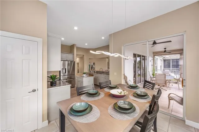 a dining room with furniture and a chandelier
