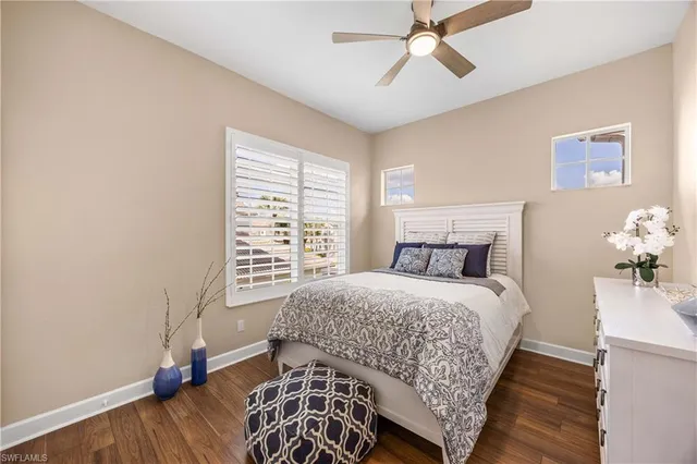 a en suite bathroom with a granite countertop sink a toilet a mirror and shower