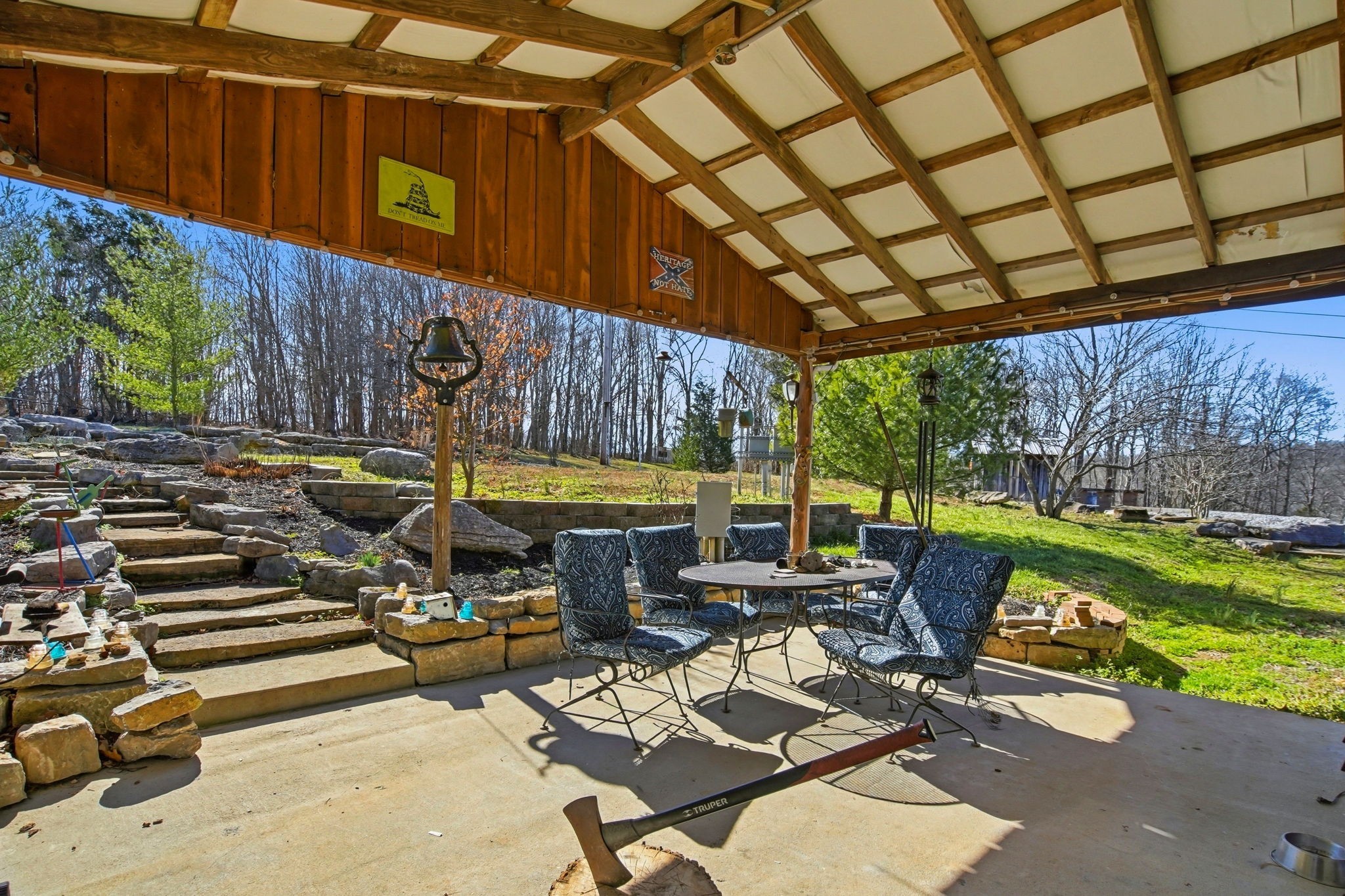 3611 Cooper Nicholson Road Pleasant View, TN 37146 - Photo 36 of 60 a view of a patio with a table and chairs under an umbrella with a small yard
