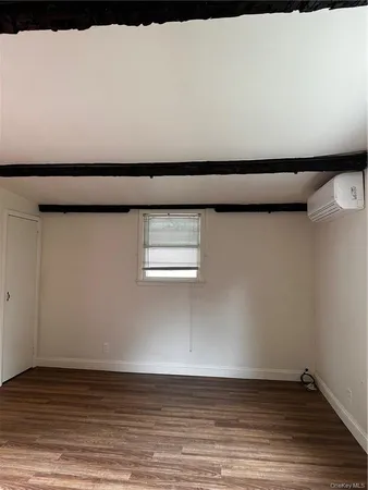 a view of a closet with wooden floor
