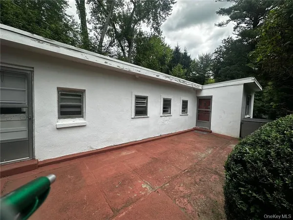 a backyard of a house with large trees