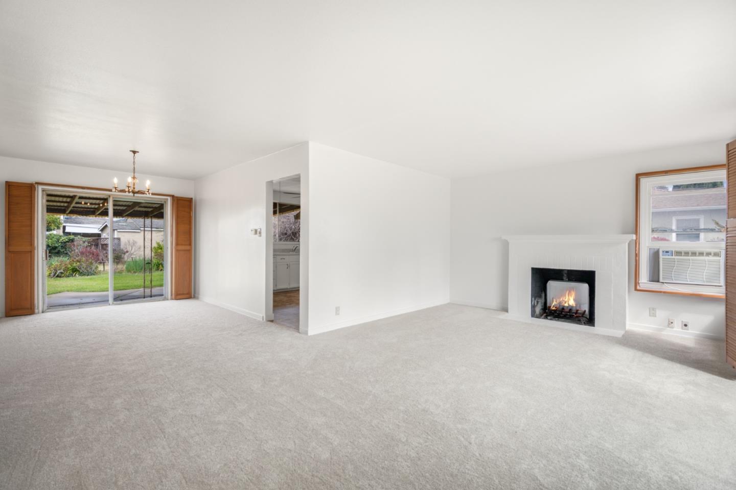 3961 Golf Drive San Jose, CA 95127 - Photo 4 of 14 a view of an empty room with a fireplace and a window