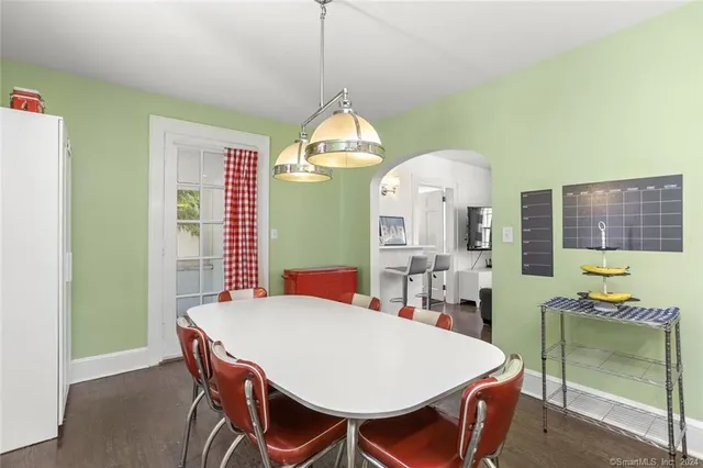 a view of a dining room with furniture and a chandelier