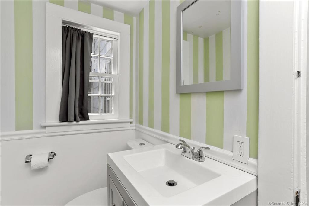 61 Hillandale Road Westport, CT 06880 - Photo 13 of 40 a bathroom with a sink and a mirror