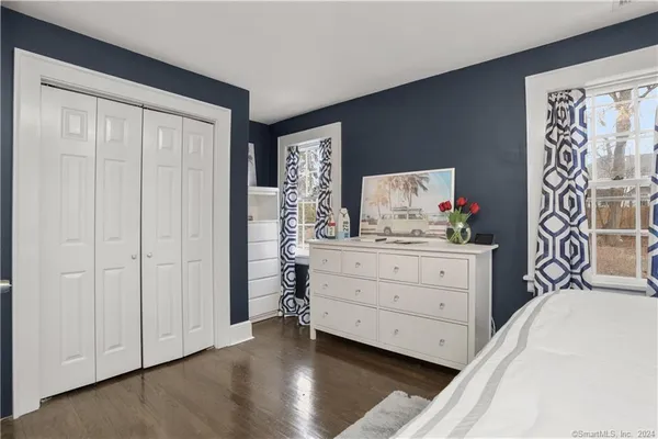 a bedroom with a bed and a dresser in it