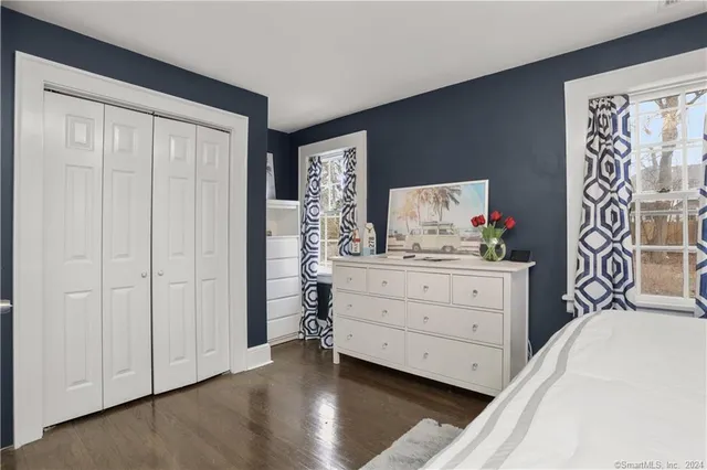 a bedroom with a bed and a dresser in it