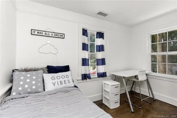 a bedroom with a large bed and a mirror