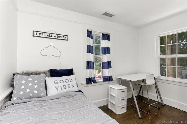 a bedroom with a large bed and a mirror