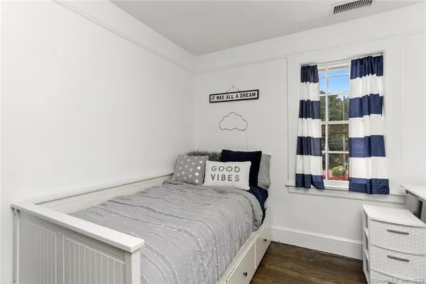 a bedroom with furniture and a window