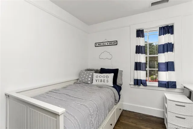 a bedroom with furniture and a window