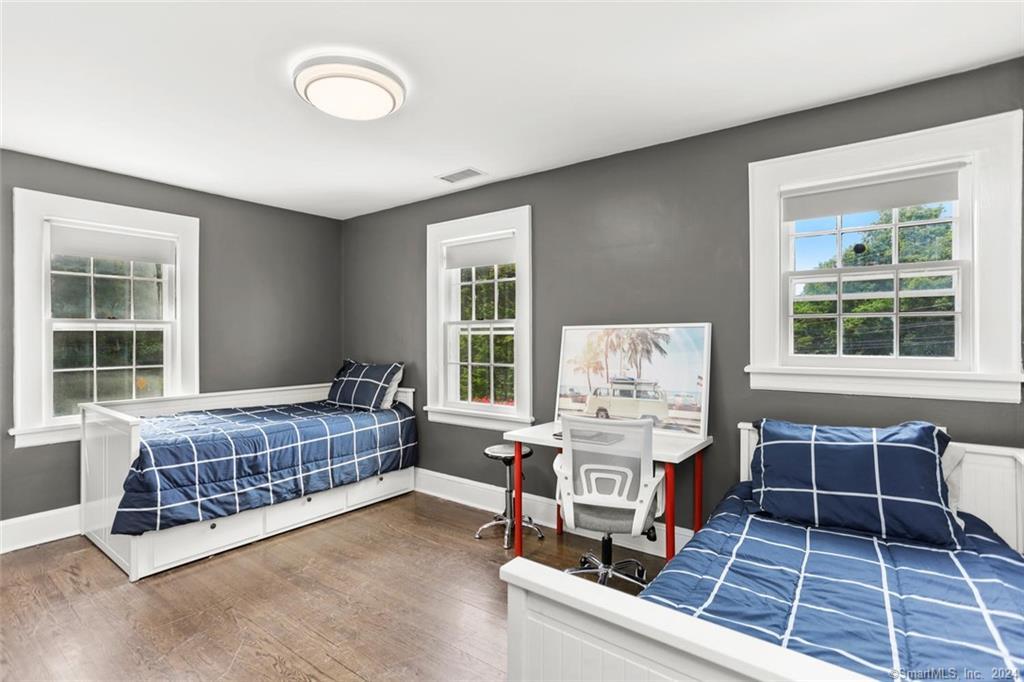 61 Hillandale Road Westport, CT 06880 - Photo 21 of 40 a living room with a baby crib furniture and a window