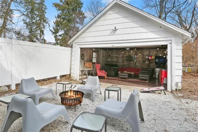 a view of a patio with a dining table and chairs under an umbrella