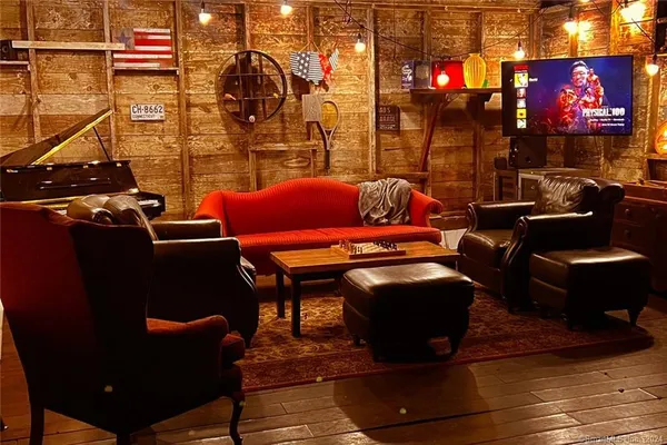 a roof deck with table and chairs