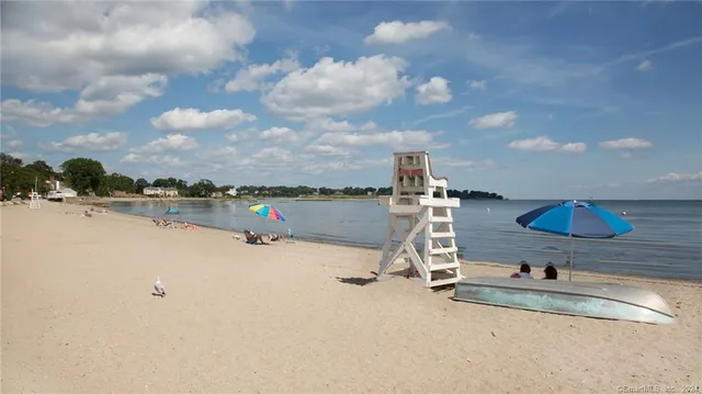 a view of a lake with outdoor seating space