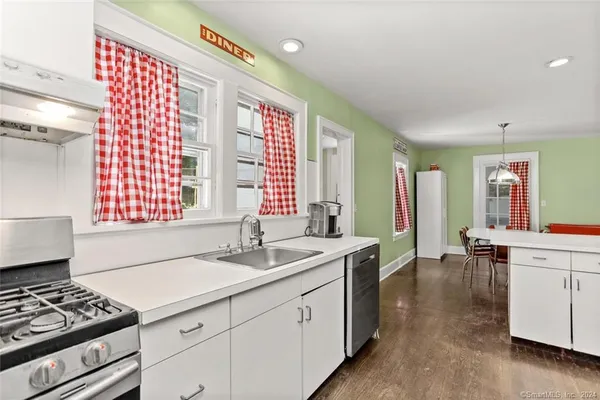 a kitchen that has a sink and a stove