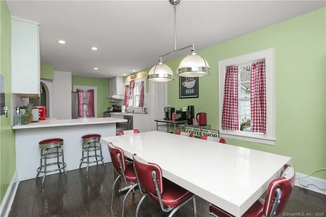 a view of a dining room with furniture window and wooden floor