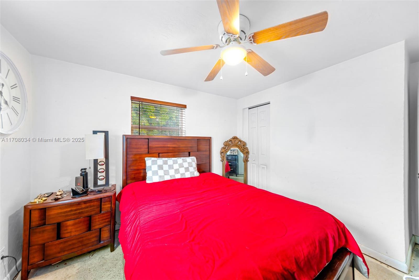 5737 Greene Street Hollywood, FL 33021 - Photo 13 of 19 a blue bed sitting in a bedroom next to a window