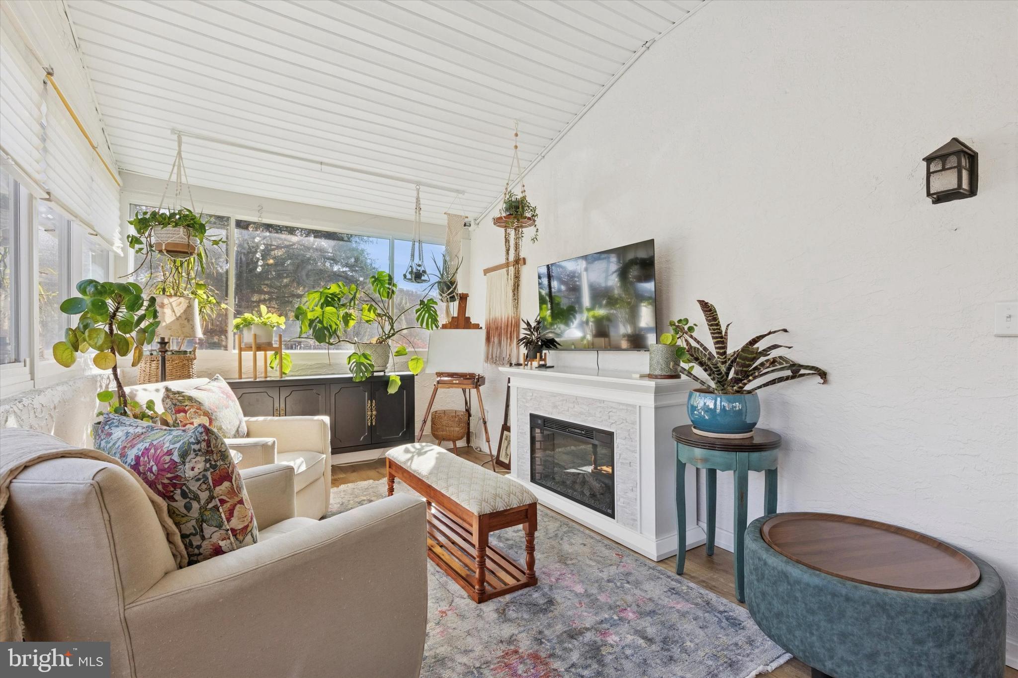 5 Mary Jane Street Spring Mount, PA 19473 - Photo 14 of 25 a living room with furniture a fireplace and a potted plant