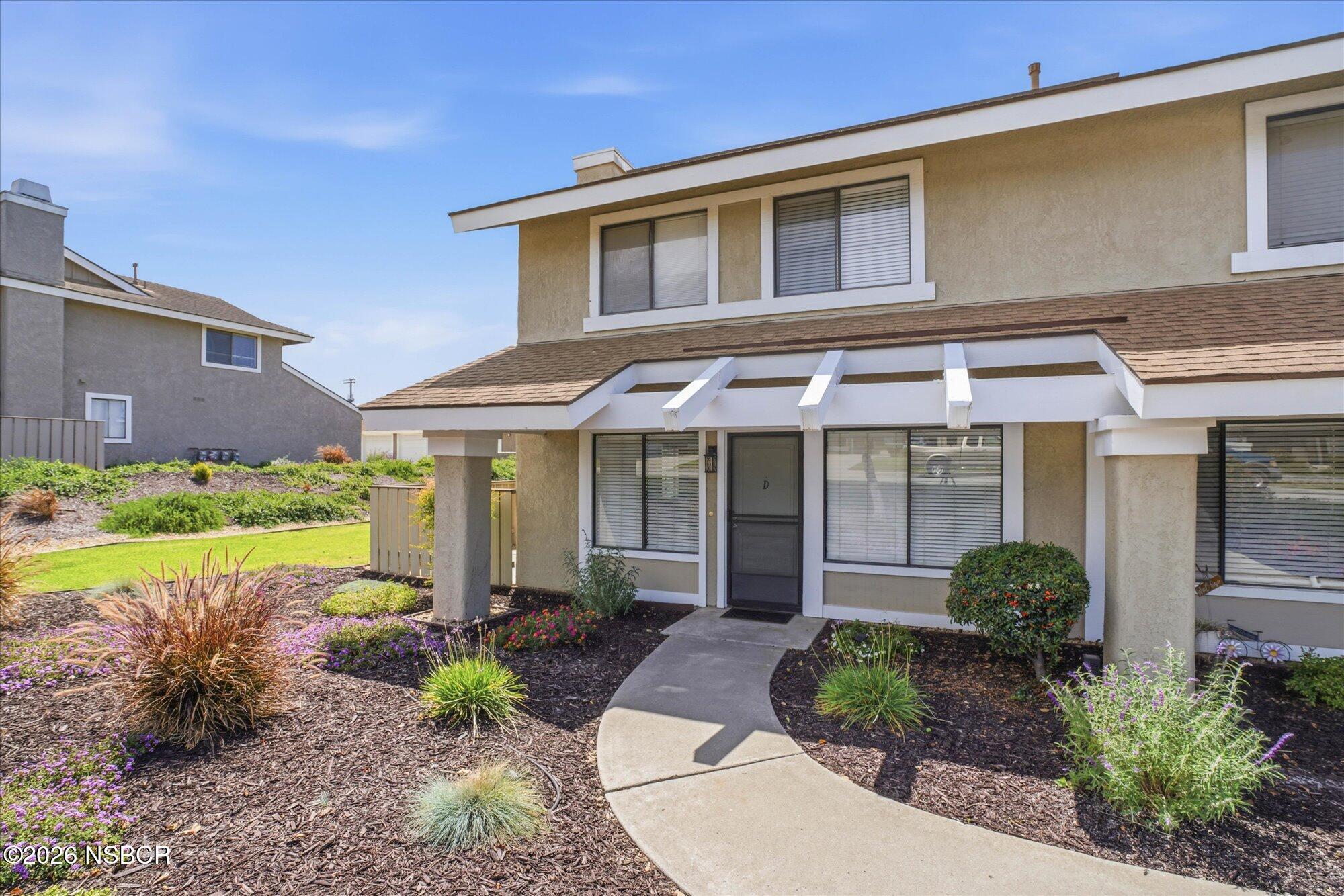 1192 Sumner Place, Unit D Santa Maria, CA 93455 - Photo 1 of 18 a front view of a house with garden