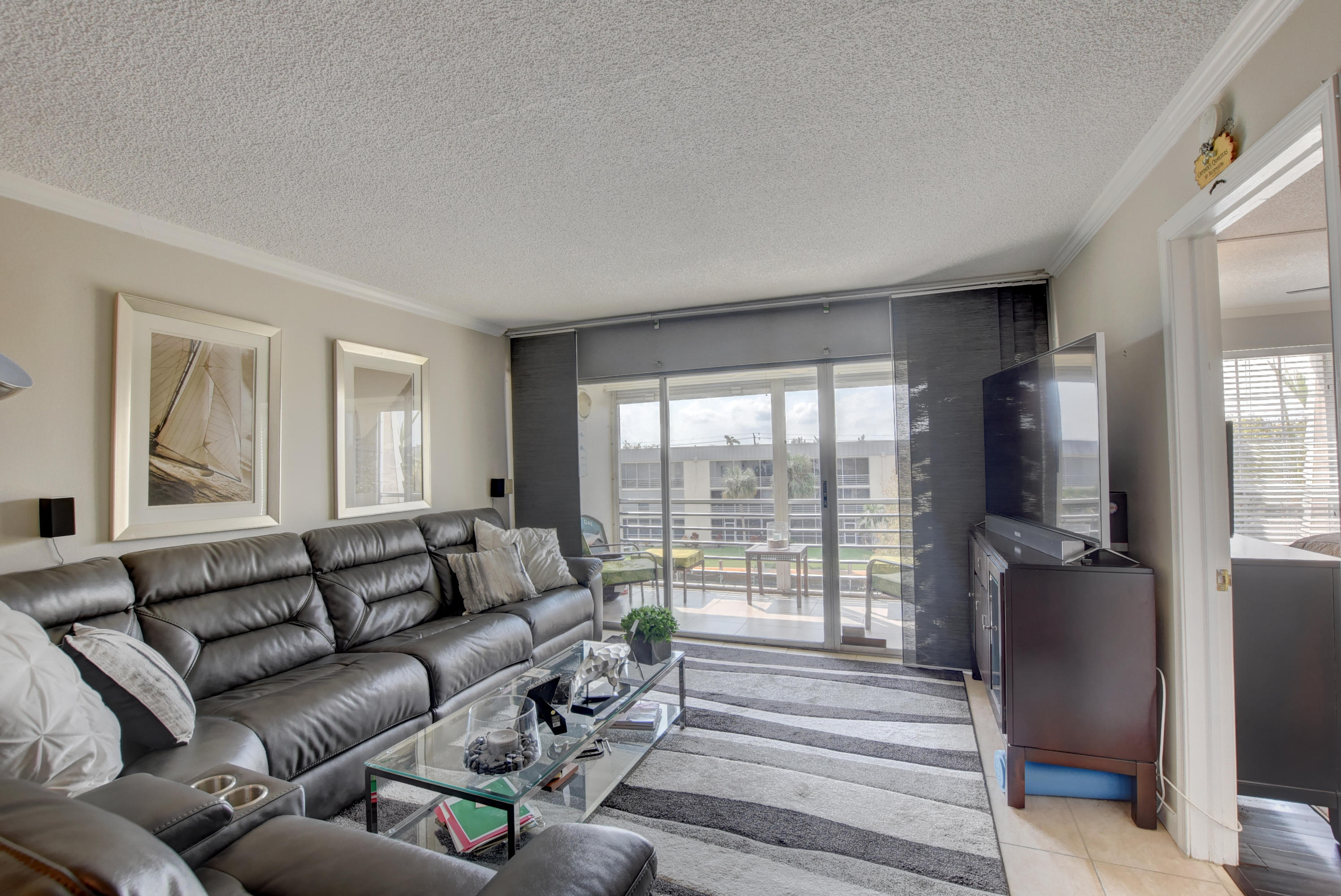 765 Jeffery Street, Unit 1306 Boca Raton, FL 33487 - Photo 14 of 34 a living room with furniture and a flat screen tv