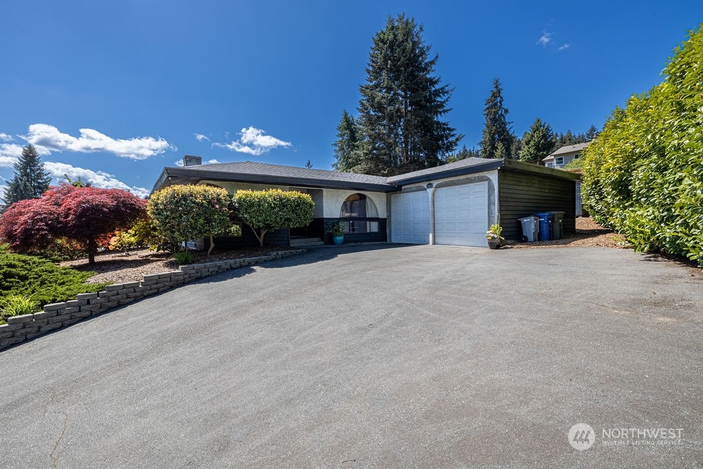 22422 4th Avenue Southeast Bothell, WA 98021 - Photo 4 of 39 a view of a house with a yard and garage