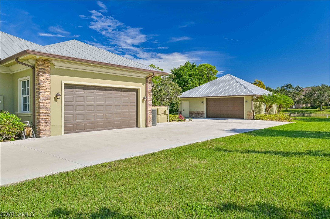 18240 Riverwind Drive Alva, FL 33920 - Photo 10 of 50 a front view of a house with a yard and garage