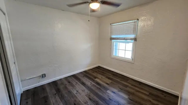 a room with wooden floor and natural light