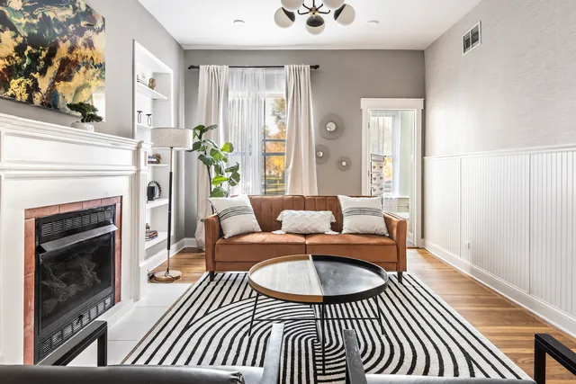 a living room with furniture and a fireplace