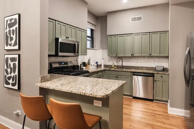 a kitchen with a stove a sink and a refrigerator