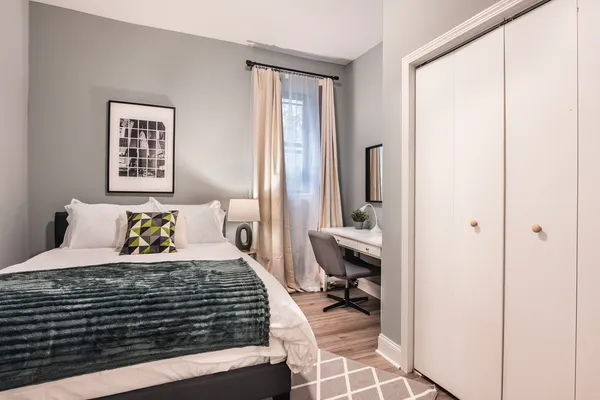 a bedroom with a bed and a window